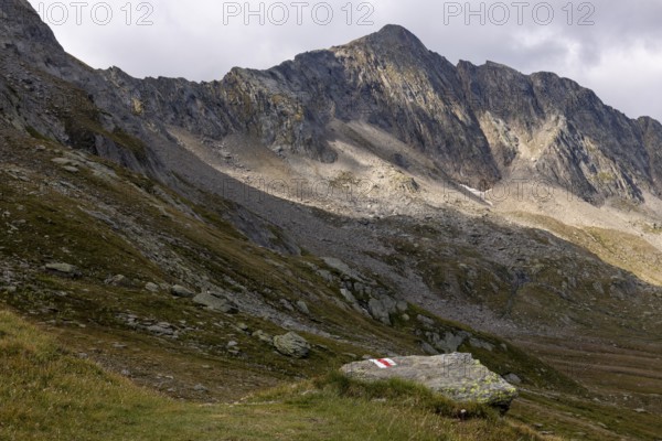 Hiking trail marker at Passo del Sole with Bassa di Pos Lei, Quinto, Ticino, Switzerland