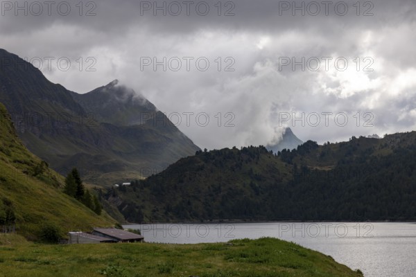 On the shore of Lago Ritom, view towards Passo Sole, Airolo, Ticino, Switzerland