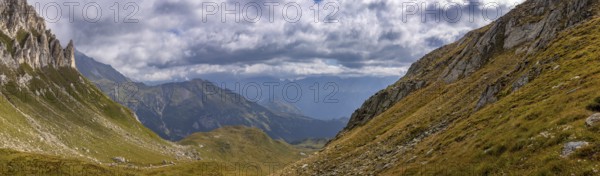View from Passo del Sole towards Blenio Valley and Lukmanier, on the left steep rock faces at Campanítt, Pizz di Colómb, Olivone, Ticino, Switzerland