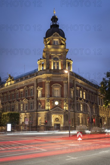 Old head post office with light strips of moving cars at the blue hour, Hamburg, Germany