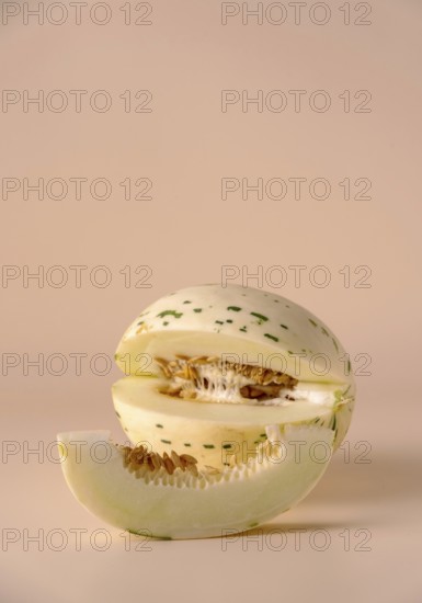 Hybrid honeydew melon on a beige background