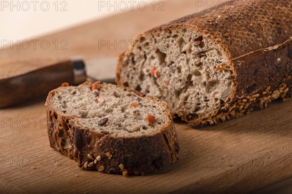 Slices of whole grain bread with carrots and seeds, close-up