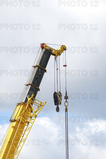 Yellow crane boom against sky background, copy space