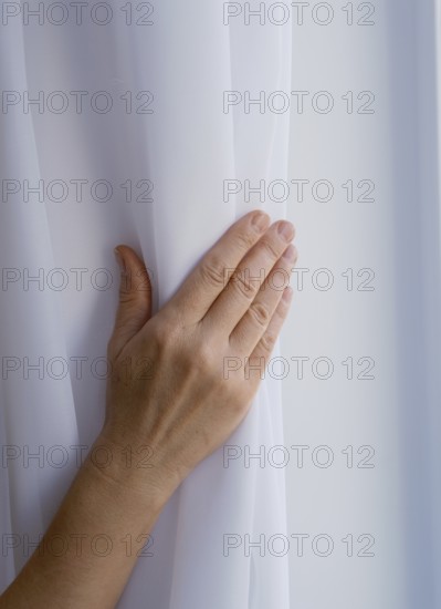 Female hand on nylon fabric