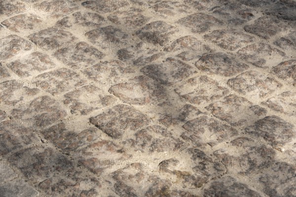 Cobblestone pavement, textured background, copy space