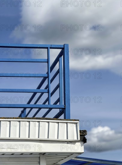 Blue railings on white pier, space for text