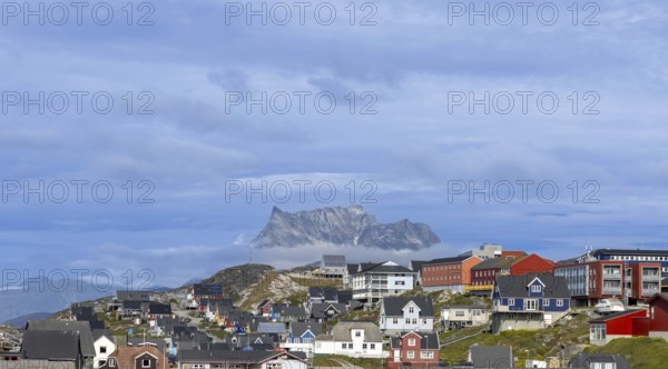 Panoramic view of Greenland capital Nuuk with colored houses located near fjords and icebergs