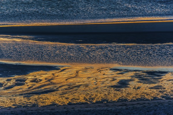 Evening sun reflected in the Wadden Sea at low tide, sun, sea, natural spectacle, Sylt
