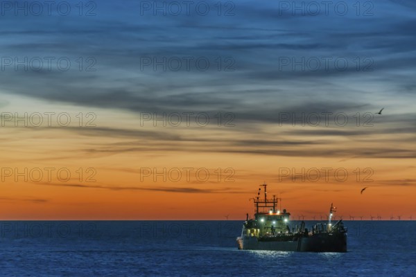 Coastal defence, hopper dredger, suction dredger in the evening light off the coast of the North Sea island of Sylt