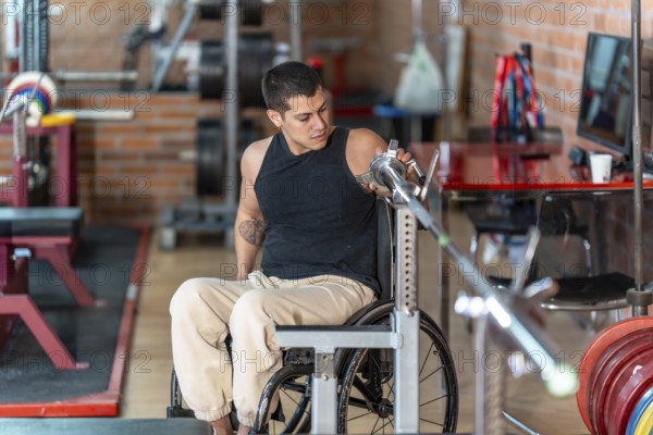 Disabled man in a wheelchair performing weight training with a barbell at a gym, focusing on strength, determination, and adaptive fitness for an inclusive workout