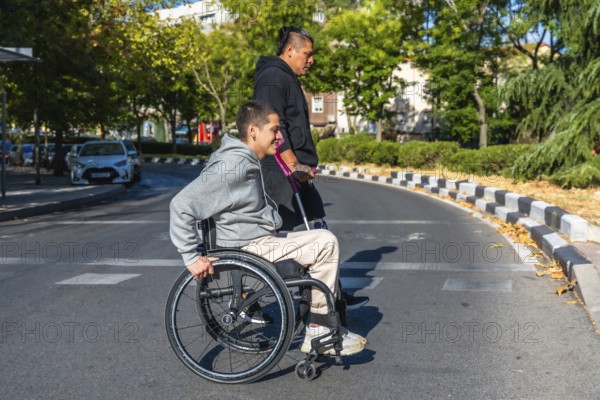 Two diverse young individuals with disabilities walking on a city road, one person using a wheelchair and the other a prosthetic leg, embodying urban mobility, inclusion, and friendship