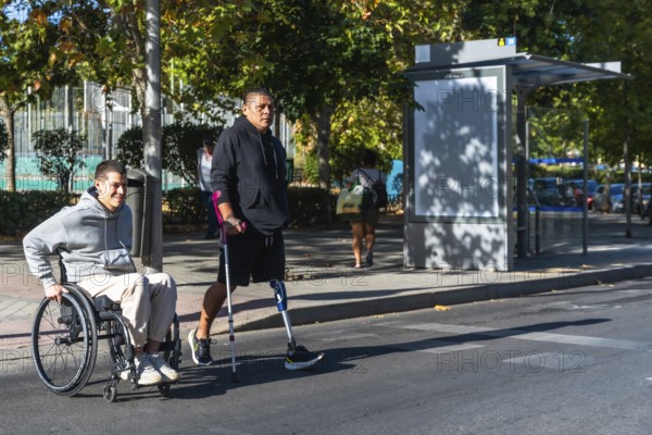 Two amputee men, one using a wheelchair and the other a prosthetic leg with crutch, navigating an urban environment, symbolizing friendship, support, and active movement