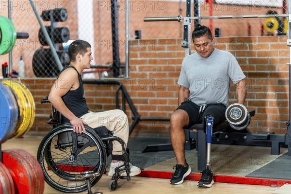 Two men with disabilities, one using a wheelchair and another with a prosthetic leg, engaging in fitness activities and supporting each other during a workout session at the gym