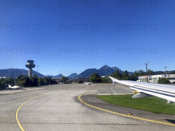 View of the tower and the Hochstaufen, Salzburger Land, Austria, from the aircraft on take-off from Salzburg Airport