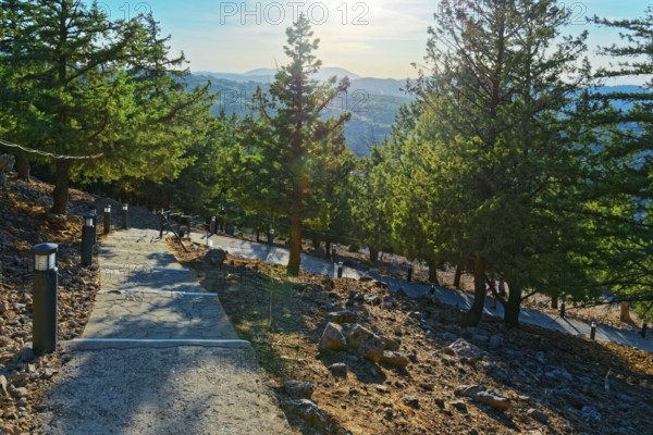 Path with over 300 steps to the chapel of the Virgin Mary Tsambika (Kyra Psili) in a sunny mountain landscape with views of forests and the distance, Church of the Virgin Mary Tsambika (Kyra Psili), Archangelos, Rhodes Island, Greece