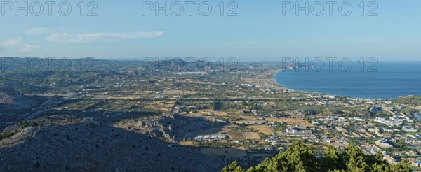 Expansive coastal landscape of Kolymbia and Faliraki, with mountain ranges and coastline under a clear blue sky, Church of the Virgin Mary Tsambika (Kyra Psili), Archangelos, Rhodes Island, Greece