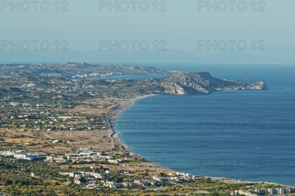 Wide coastline of Kolymbia with sandy beach and blue sea under a clear sky, Church of the Virgin Mary Tsambika (Kyra Psili), Archangelos, Rhodes Island, Greece