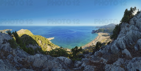 Panoramic view from the cliffs at Kyra Psili church to the sandy beach of Tsambika with deep blue sea and wooded hills, Church of the Virgin Mary Tsambika (Kyra Psili), Archangelos, Rhodes Island, Greece