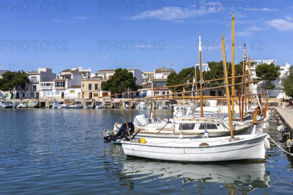 Portocolom fishing village on Majorca with boats and colourful houses Holiday by the sea in Portocolom, Spain