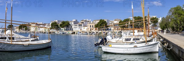 Portocolom fishing village on Majorca panorama with boats and colourful houses holiday by the sea trip in Portocolom, Spain