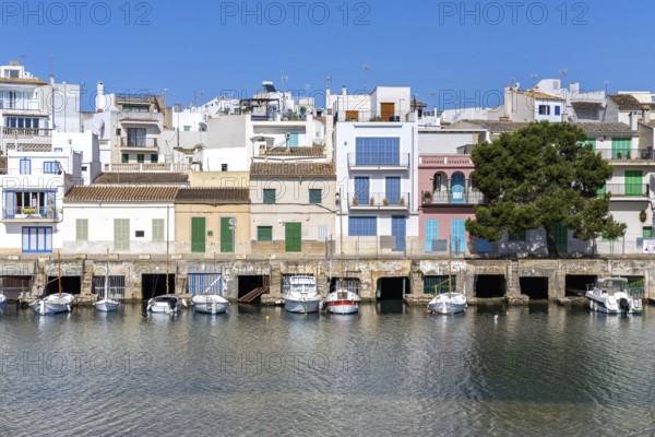 Colourful houses in Portocolom Fishing village on Majorca with boats Seaside holiday in Portocolom, Spain