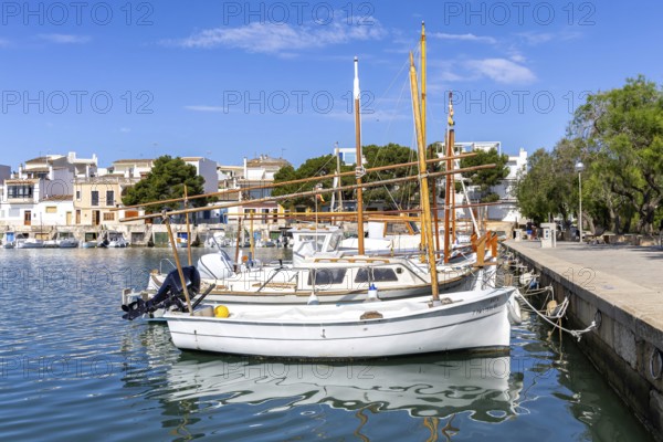 Portocolom fishing village on Majorca with boats and colourful houses Holiday by the sea in Portocolom, Spain