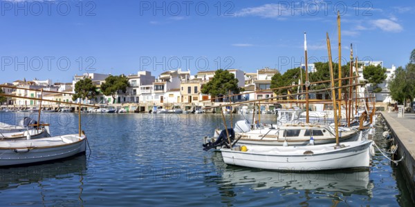 Portocolom fishing village on Majorca with boats and colourful houses Holiday by the sea Panorama trip in Portocolom, Spain