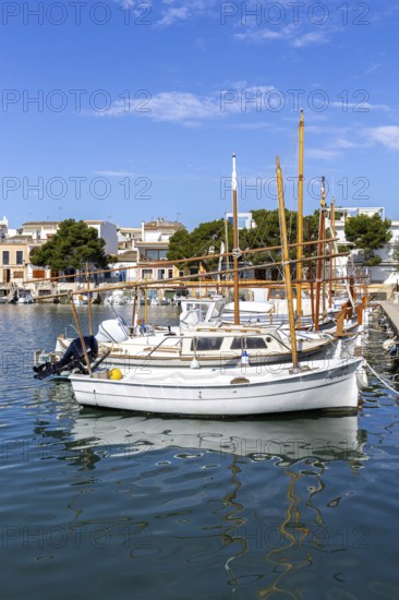 Portocolom fishing village on Majorca with boats and colourful houses Holiday by the sea in Portocolom, Spain