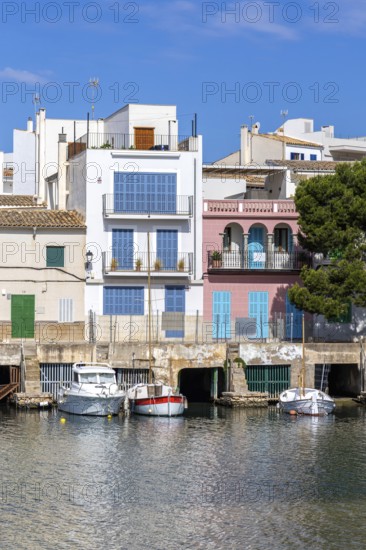 Colourful houses in Portocolom Fishing village on Majorca with boats Seaside holiday in Portocolom, Spain