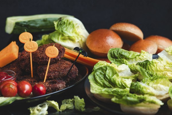 Burgers with Halloween decorations and colourful ingredients such as lettuce and tomatoes