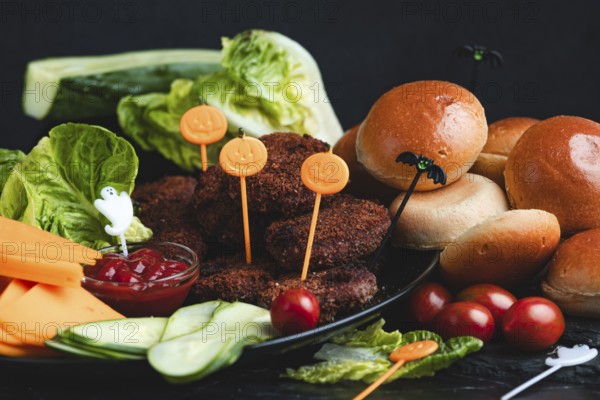 Burgers with Halloween decorations and colourful ingredients such as lettuce and tomatoes