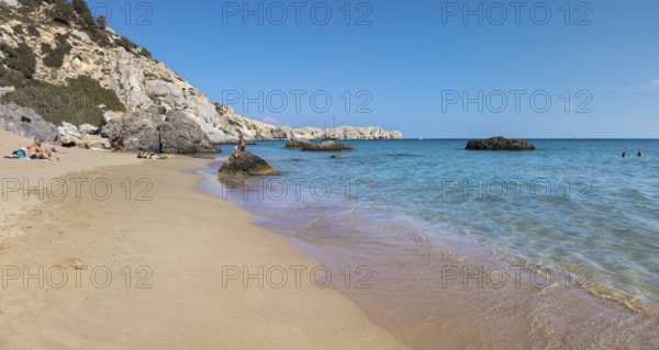 Quiet Tsambika beach with rocks, blue sea and clear sky, Tsambika beach, Archaggelos, Rhodes island, Greece