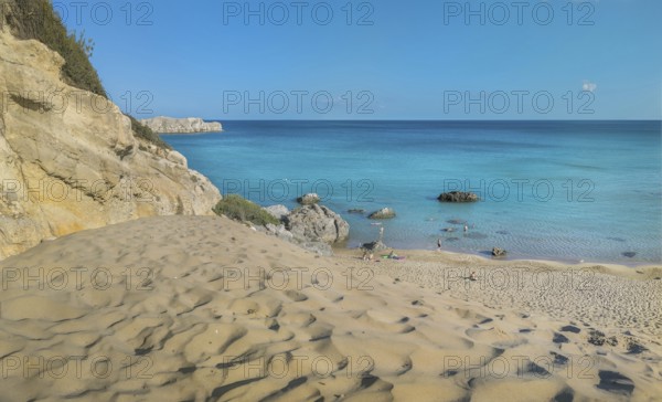 Tsambika beach with fine sand and large rocks on a sunny day, azure blue water and clear sky, Tsambika beach, Archaggelos, Rhodes island, Greece