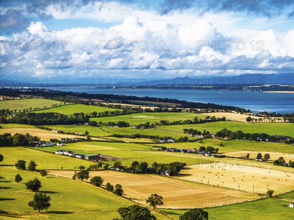 Fields and farms over Scotish farms and Forth Estuary from drone, House of the Binns, Binns Tower, Linlithgow, Scotland, UK