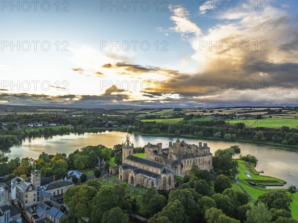 Sunset over Linlithgow Palace from a drone, Linlithgow Loch, West Lothian, Scotland, United Kingdom