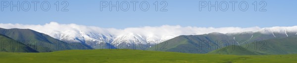 Wide meadow in front of a snow-covered mountain range, landscape near Saratovka, Lesser Caucasus, Lorikeet Province, Armenia