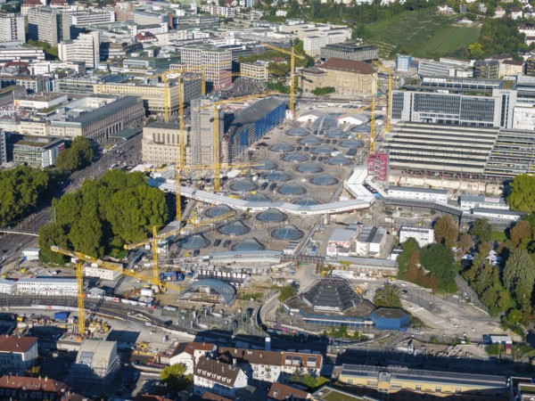 Spacious construction site with modern glass buildings and cranes in a sunny urban landscape, large construction site, Stuttgart railway station, Stuttgart 21, Baden-Württemberg, Germany