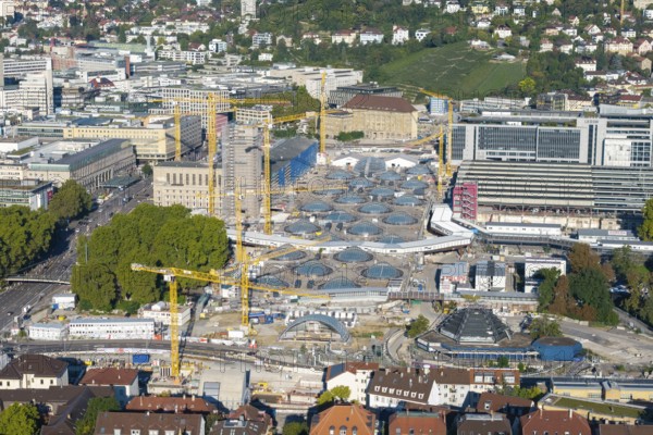 Modern construction site with glass roofs and cranes in an urban environment, surrounded by trees, large construction site, Stuttgart railway station, Stuttgart 21, Baden-Württemberg, Germany