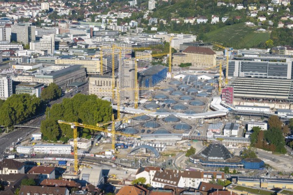 Urban construction project with glass structures and cranes, embedded in a green urban backdrop, large construction site, Stuttgart railway station, Stuttgart 21, Baden-Württemberg, Germany