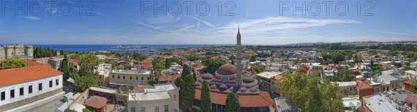 A sweeping panoramic view of the old town of Rhodes with a minaret and the sea in the distance, Suleiman Mosque, Medieval Town of Rhodes, Rhodes Island, Greece