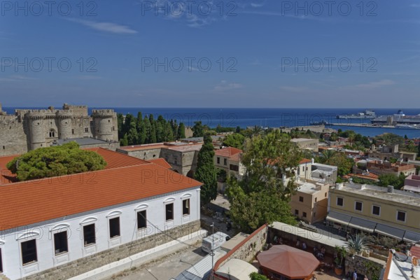 View of a historic town with castle, red roofs and sea in the background, Medieval Town of Rhodes, Rhodes Island, Greece