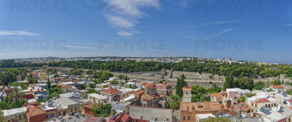 Historic old town with colourful houses and green trees under a clear blue sky, Roloi Clock Tower, Medieval Town of Rhodes, Rhodes Island, Greece