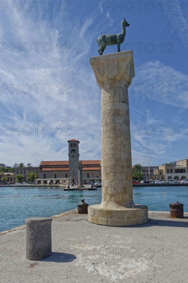 Colossus of Rhodes rises at the harbour of Mandraki, Colossus of Rhodes Mandraki Harbour, Medieval Town of Rhodes, Rhodes Island, Greece