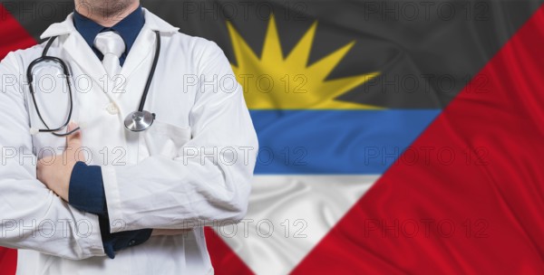 Male doctor with stethoscope on Antigua and Barbuda flag. Doctor holding stethoscope on Antigua and Barbuda flag