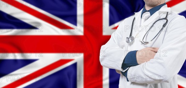 United Kingdom healthcare concept. Male doctor on United Kingdom flag. Doctor with crossed arms on United Kingdom flag