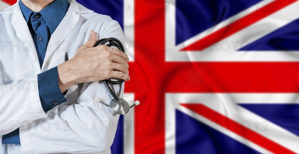 Doctor with stethoscope on United Kingdom flag. Doctor holding stethoscope on British flag