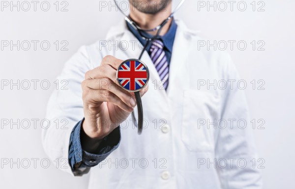 United Kingdom healthcare system, doctor holding stethoscope. United Kingdom health and medical insurance concept