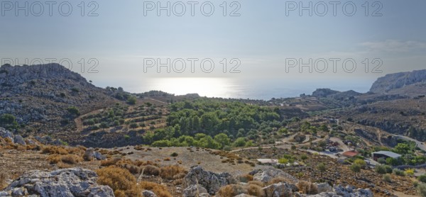 View over a barren range of hills near Stegna to the sea under the morning sun, Stegna, Archangelos, Rhodes Island, Greece