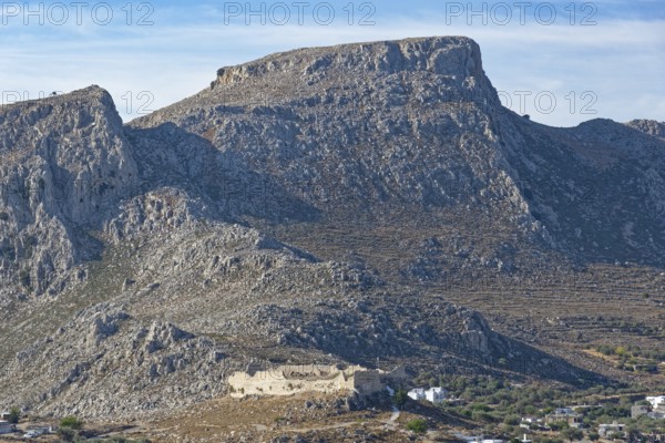 Rocky mountain landscape with the castle ruins of Archangelos under a light blue sky, Archangelos, Rhodes Island, Greece
