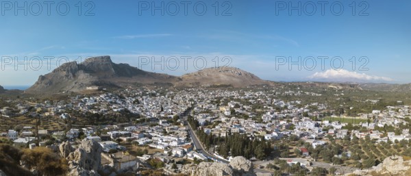 Panorama of the town of Archangelos in a sunny landscape, surrounded by mountains under a clear sky, Archangelos, Rhodes Island, Greece